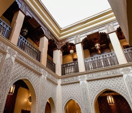 Beautiful interior courtyard of a traditional Moroccan riad in Marrakesh showcasing intricate design.