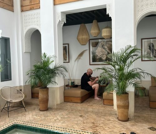 A serene moment in a beautifully designed Moroccan riad courtyard with a pool.